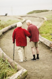 Photo of older couple walking on path