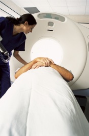 Technician preparing patient for CT scan