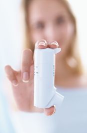 Woman holding an inhaler